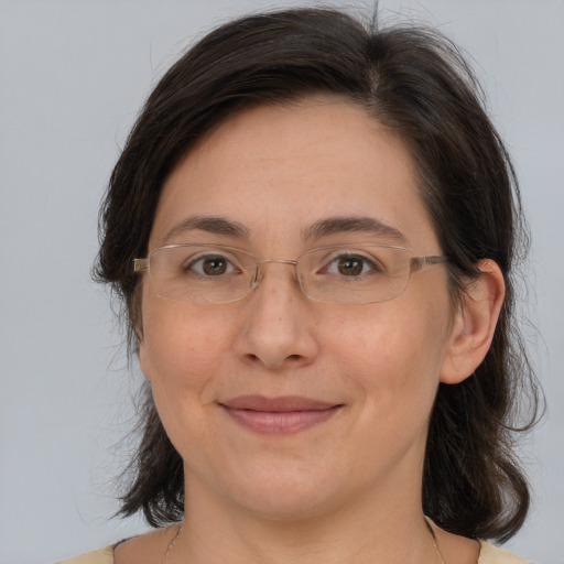 Joyful white adult female with medium  brown hair and brown eyes