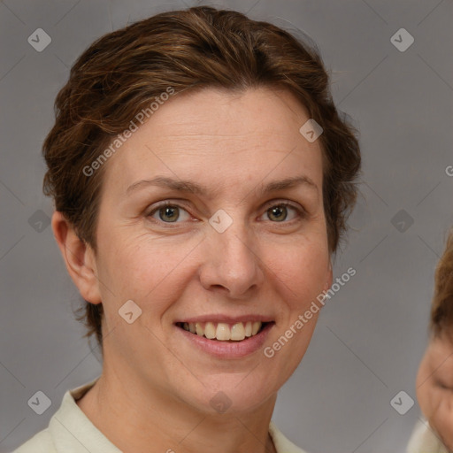 Joyful white adult female with short  brown hair and grey eyes