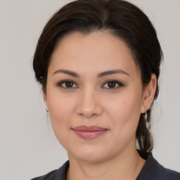 Joyful white young-adult female with medium  brown hair and brown eyes