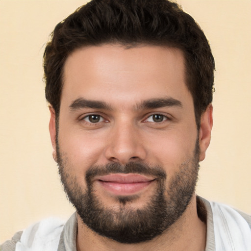 Joyful white young-adult male with short  brown hair and brown eyes