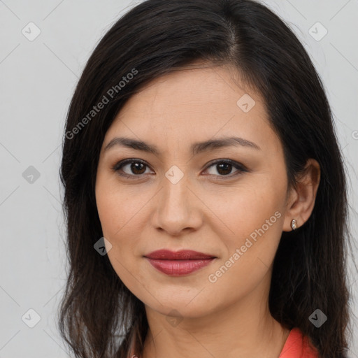 Joyful latino young-adult female with long  brown hair and brown eyes