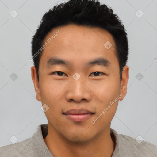 Joyful asian young-adult male with short  black hair and brown eyes