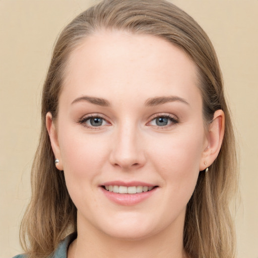 Joyful white young-adult female with long  brown hair and grey eyes