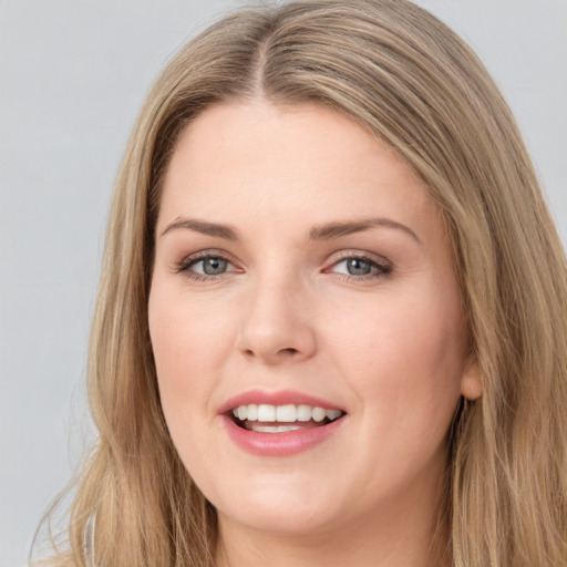 Joyful white young-adult female with long  brown hair and grey eyes