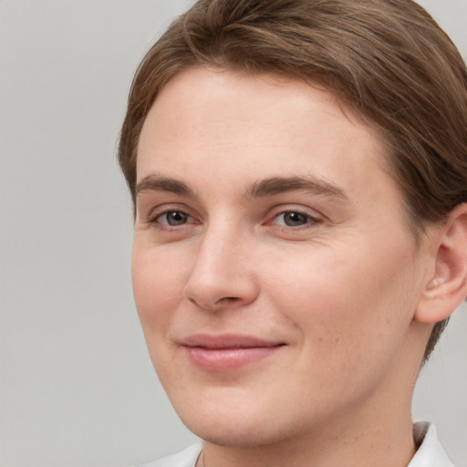 Joyful white young-adult female with short  brown hair and brown eyes