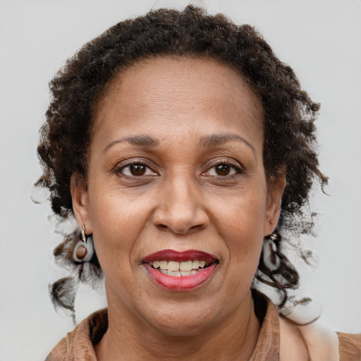 Joyful black adult female with medium  brown hair and brown eyes