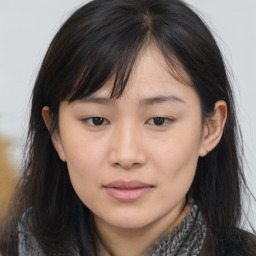 Joyful asian young-adult female with long  brown hair and brown eyes