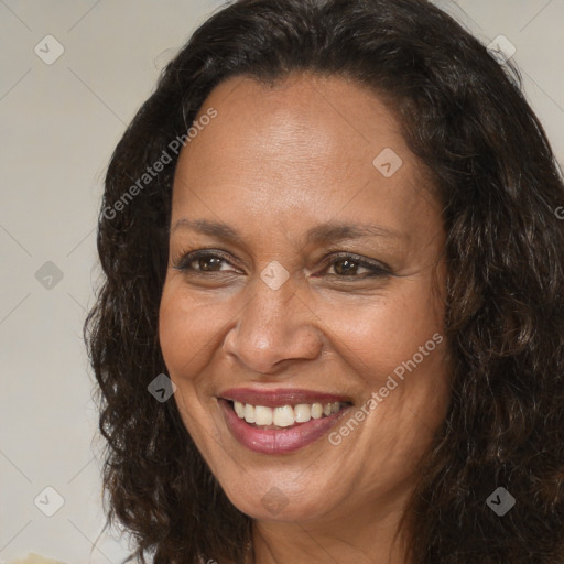 Joyful black adult female with long  brown hair and brown eyes