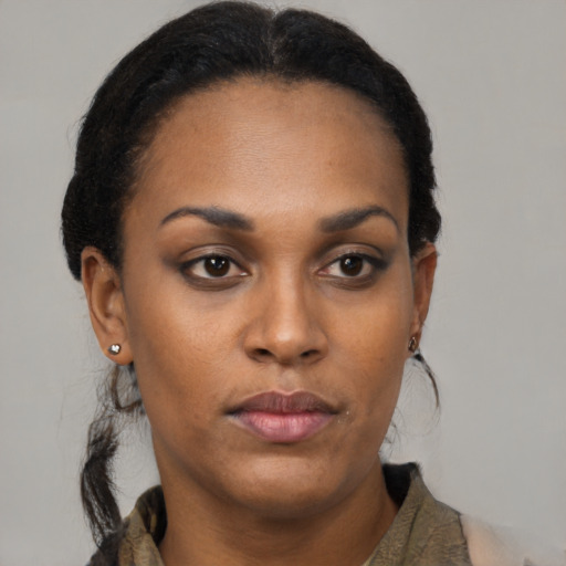Neutral black young-adult female with long  brown hair and brown eyes
