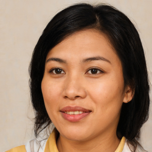 Joyful asian young-adult female with medium  brown hair and brown eyes