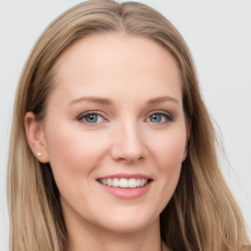 Joyful white young-adult female with long  brown hair and blue eyes