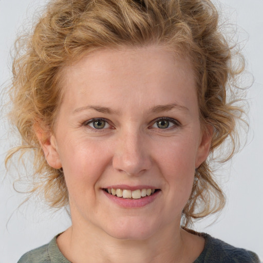 Joyful white young-adult female with medium  brown hair and blue eyes