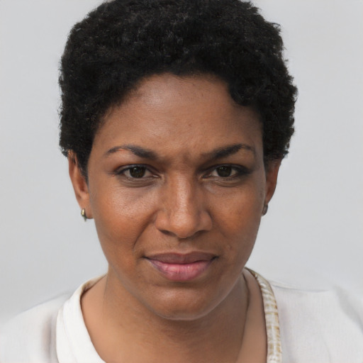 Joyful black young-adult female with short  brown hair and brown eyes