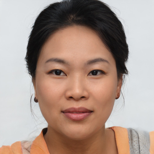 Joyful asian young-adult female with medium  brown hair and brown eyes