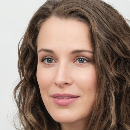 Joyful white young-adult female with long  brown hair and green eyes