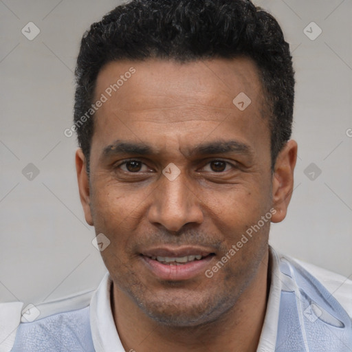 Joyful latino adult male with short  black hair and brown eyes