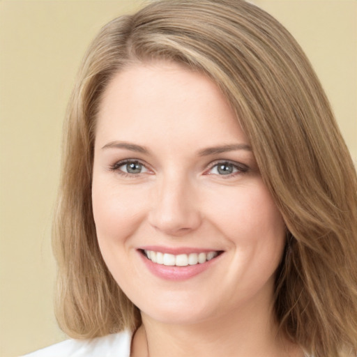 Joyful white young-adult female with long  brown hair and green eyes