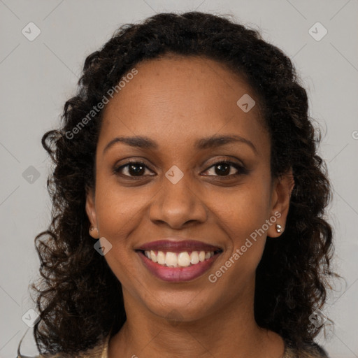 Joyful black young-adult female with long  brown hair and brown eyes