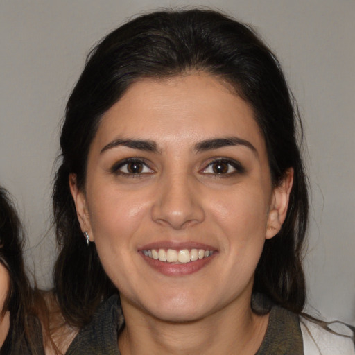 Joyful white young-adult female with medium  brown hair and brown eyes