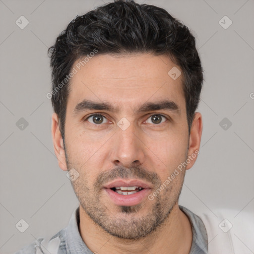 Joyful white young-adult male with short  black hair and brown eyes