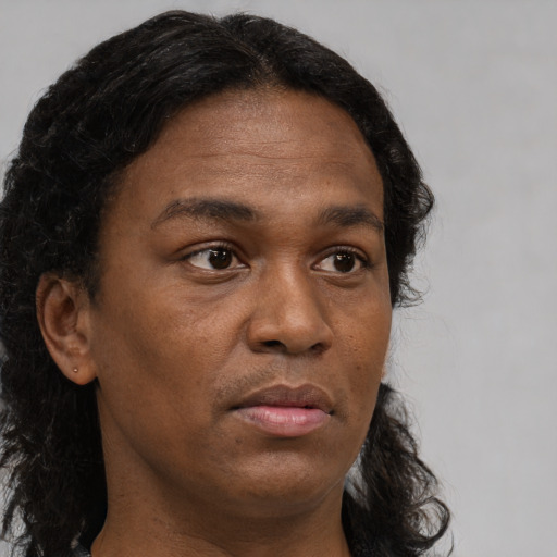 Neutral black adult male with long  brown hair and brown eyes