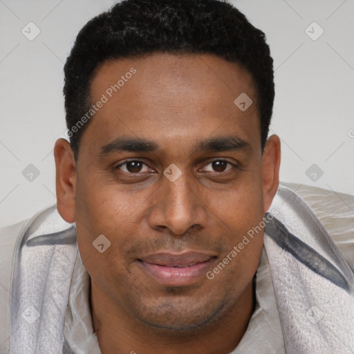 Joyful black young-adult male with short  brown hair and brown eyes