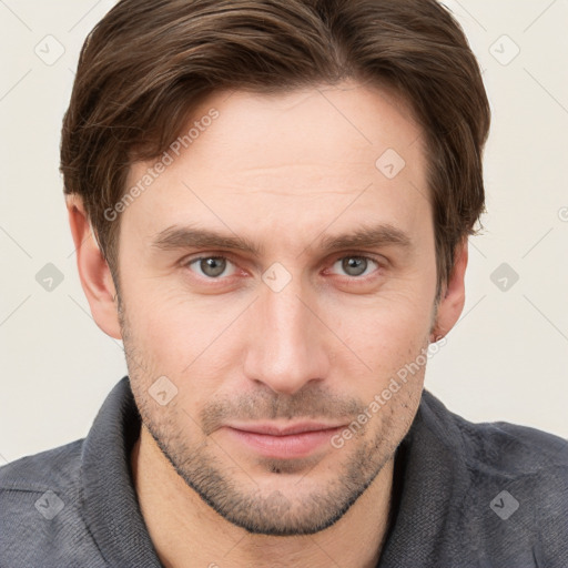 Joyful white young-adult male with short  brown hair and grey eyes