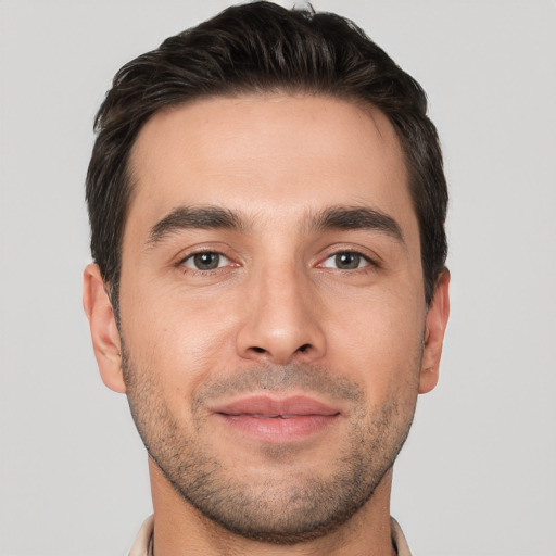 Joyful white young-adult male with short  brown hair and brown eyes