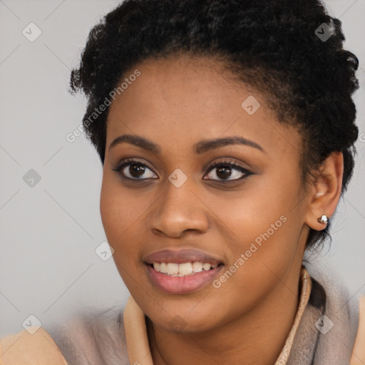 Joyful black young-adult female with short  black hair and brown eyes