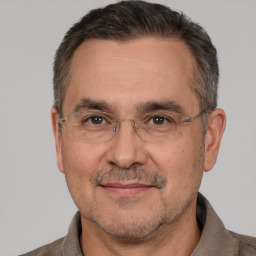 Joyful white middle-aged male with short  brown hair and brown eyes