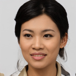 Joyful asian young-adult female with medium  black hair and brown eyes