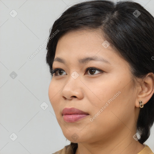 Joyful latino young-adult female with medium  brown hair and brown eyes