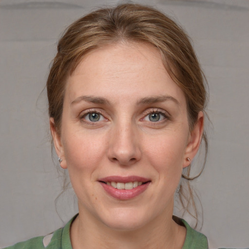 Joyful white adult female with medium  brown hair and grey eyes