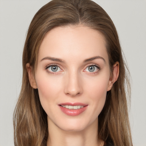 Joyful white young-adult female with long  brown hair and grey eyes