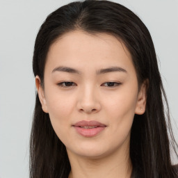 Joyful asian young-adult female with long  brown hair and brown eyes