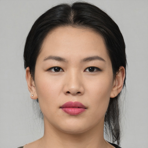 Joyful asian young-adult female with medium  black hair and brown eyes