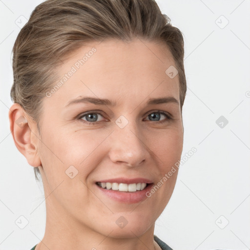 Joyful white young-adult female with short  brown hair and grey eyes