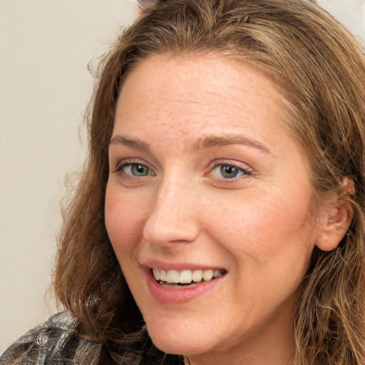 Joyful white young-adult female with long  brown hair and green eyes