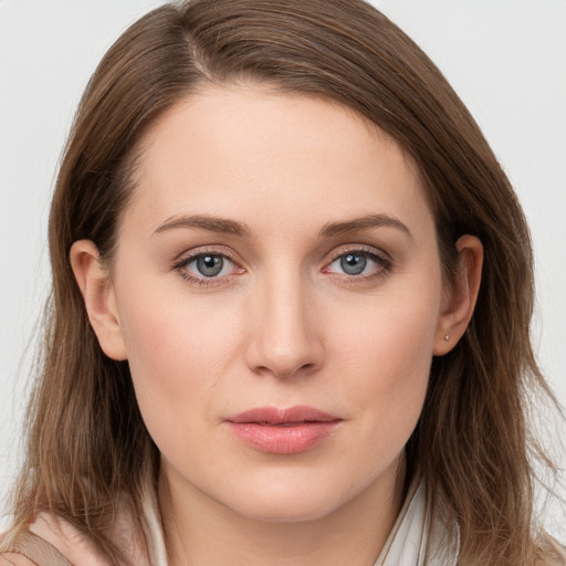 Joyful white young-adult female with long  brown hair and blue eyes