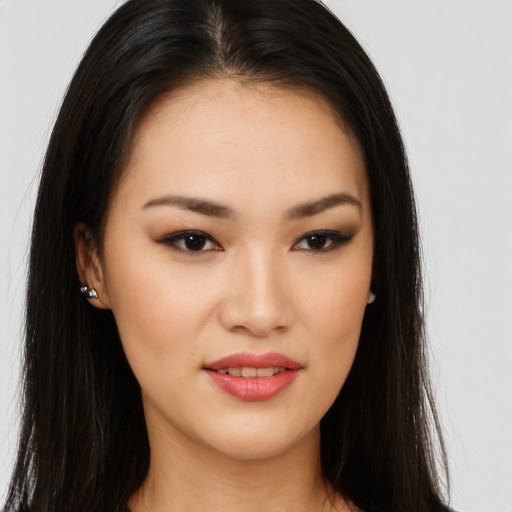 Joyful asian young-adult female with long  brown hair and brown eyes