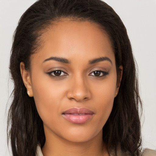 Joyful latino young-adult female with long  brown hair and brown eyes