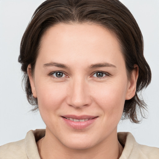 Joyful white young-adult female with medium  brown hair and brown eyes