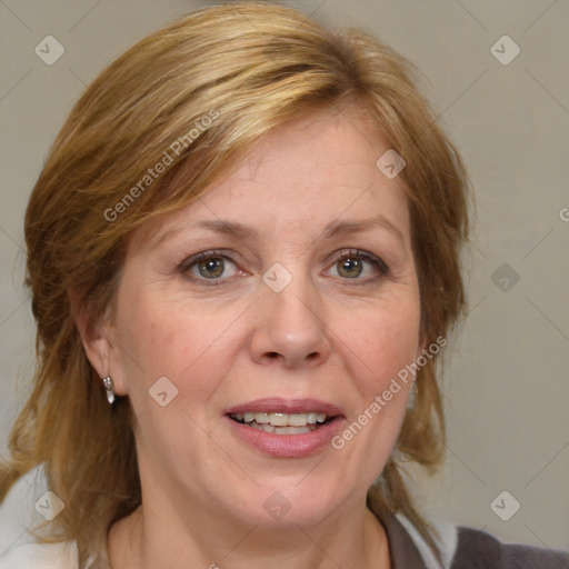 Joyful white adult female with medium  brown hair and blue eyes