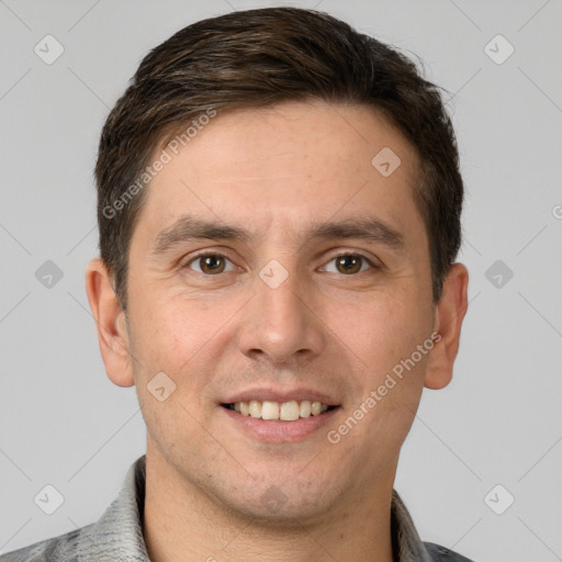 Joyful white young-adult male with short  brown hair and grey eyes