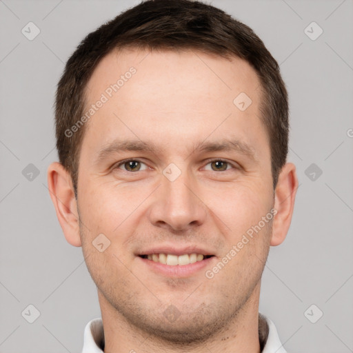 Joyful white young-adult male with short  brown hair and brown eyes