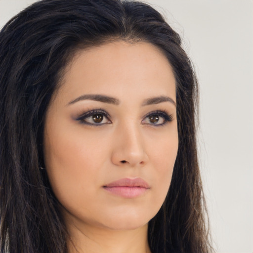 Joyful asian young-adult female with long  brown hair and brown eyes