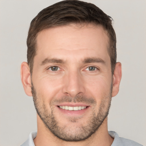 Joyful white young-adult male with short  brown hair and brown eyes