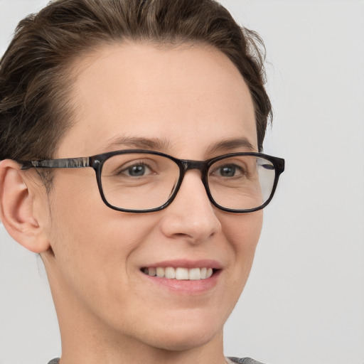 Joyful white young-adult female with short  brown hair and grey eyes