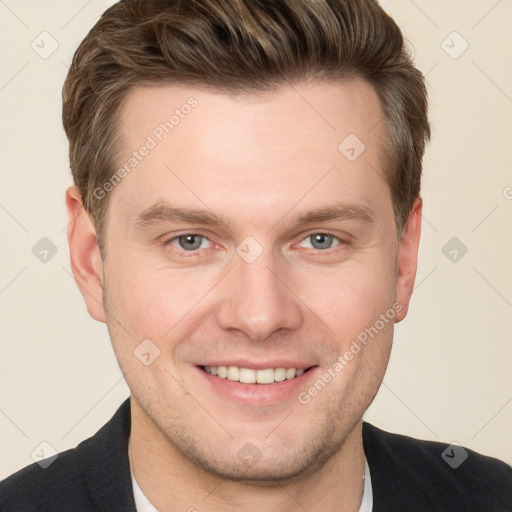 Joyful white young-adult male with short  brown hair and grey eyes