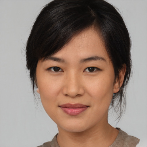 Joyful asian young-adult female with medium  brown hair and brown eyes